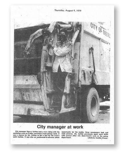 Sherry Suttles riding on a garbage truck