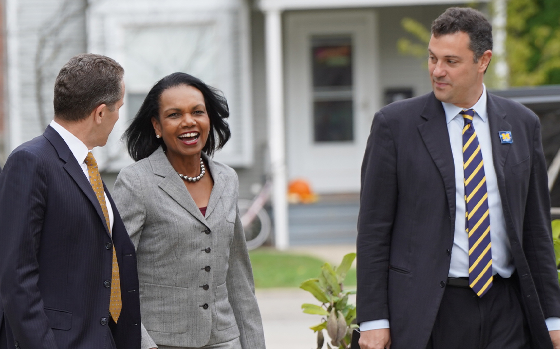 Michael S Barr, former Secretary of State Condoleezza Rice, and John Ciorciari walking outside in Ann Arbor