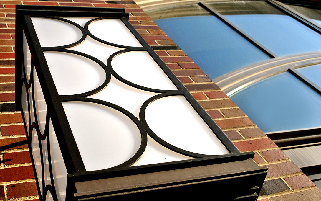 Close-up photo of a light fixture on the outside of Weill Hall