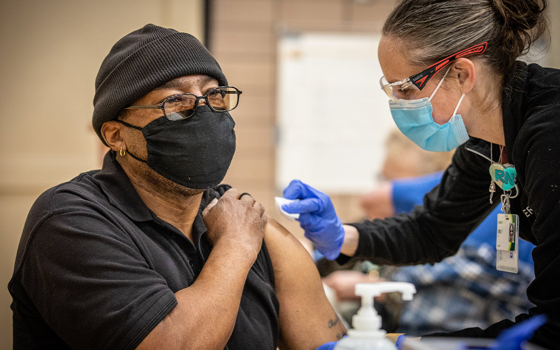 A nurse administers the COVID-19 vaccine to a teacher in Iowa (Credit: Phil Roeder / CC BY)