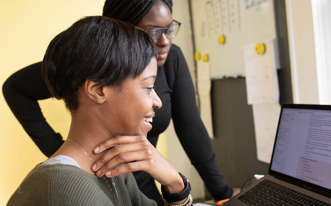 Photo of two people at a computer