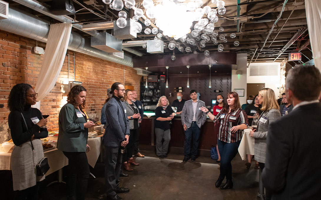 Photo of Ford School Bohnett Fellows, alumni, and friends at a reception