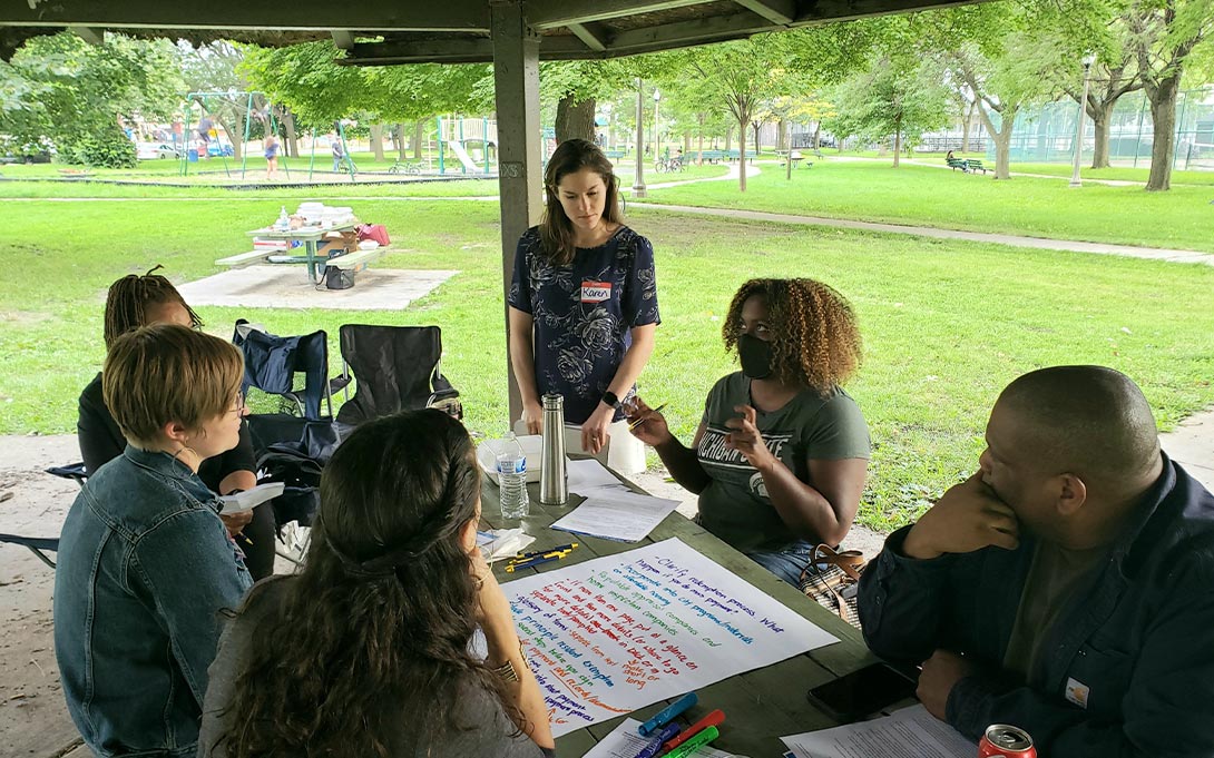 Photo of Poverty Solutions team members and Detroit community members for a land contracts session at a local park