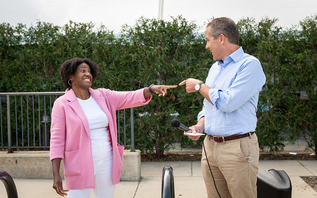 Photo of Celeste Watkins-Hayes and Michael Barr pointing toward one another