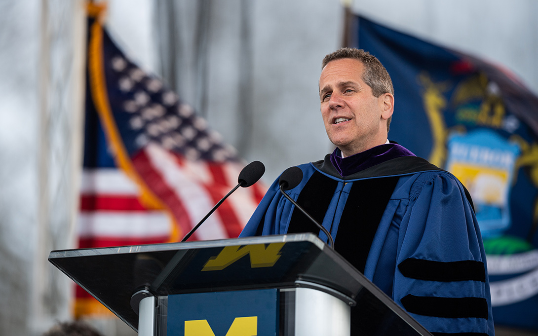 Photo of Michael Barr speaking to the classes of 2022 from a podium on stage at Elbel Field