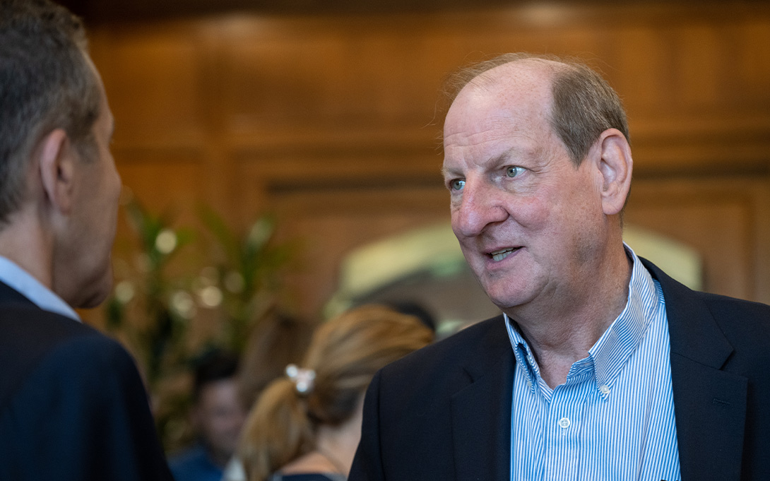 Photo of Rusty Hills speaking to Michael Barr at a reception in Weill Hall's Great Hall