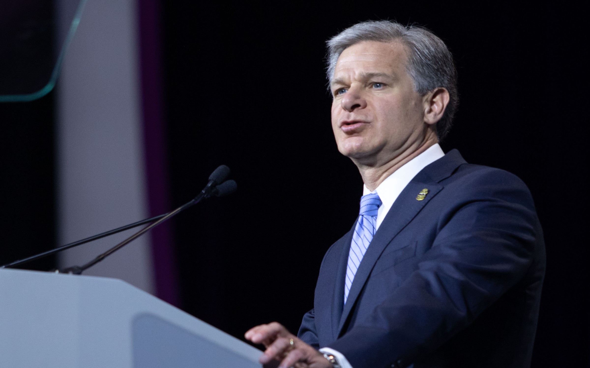 FBI Director Christopher Wray speaking at podium