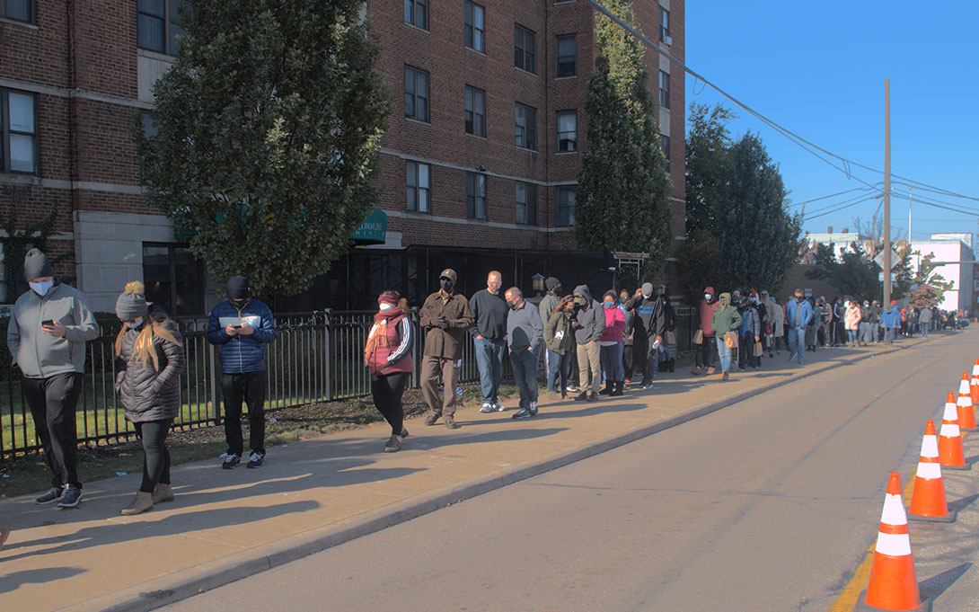 A line of people waiting outside to vote