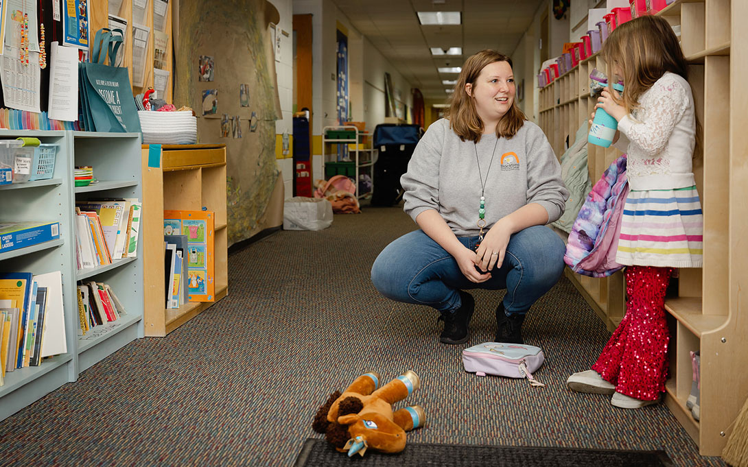 Photo of Sadie Riley-Flemming, director of Blackbird Child Care Center in Harbor Springs, greets a girl on April 19, 2024. Photos by Molly Hauxwell Currier for the University of Michigan.