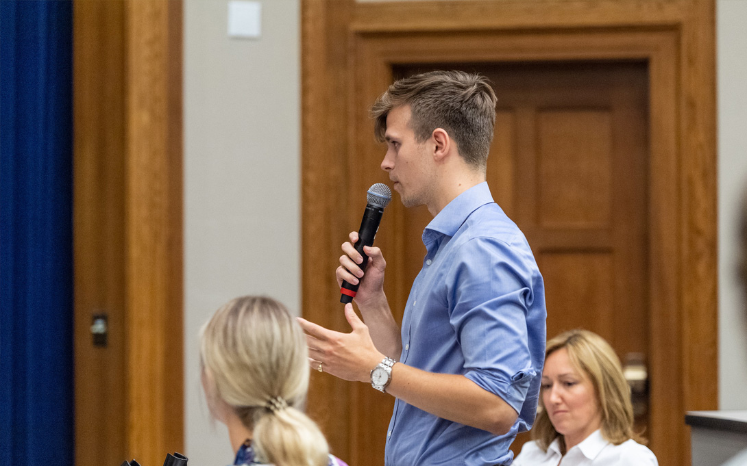 Photo of student asking question with microphone