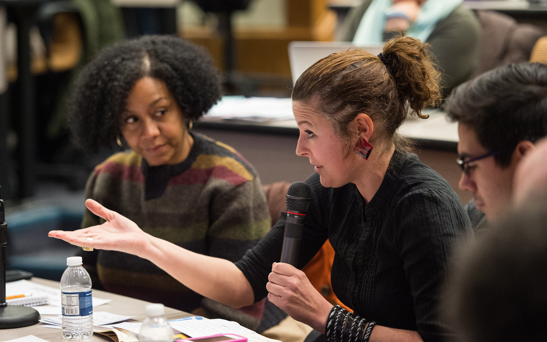 Photo of student asking question while others look on