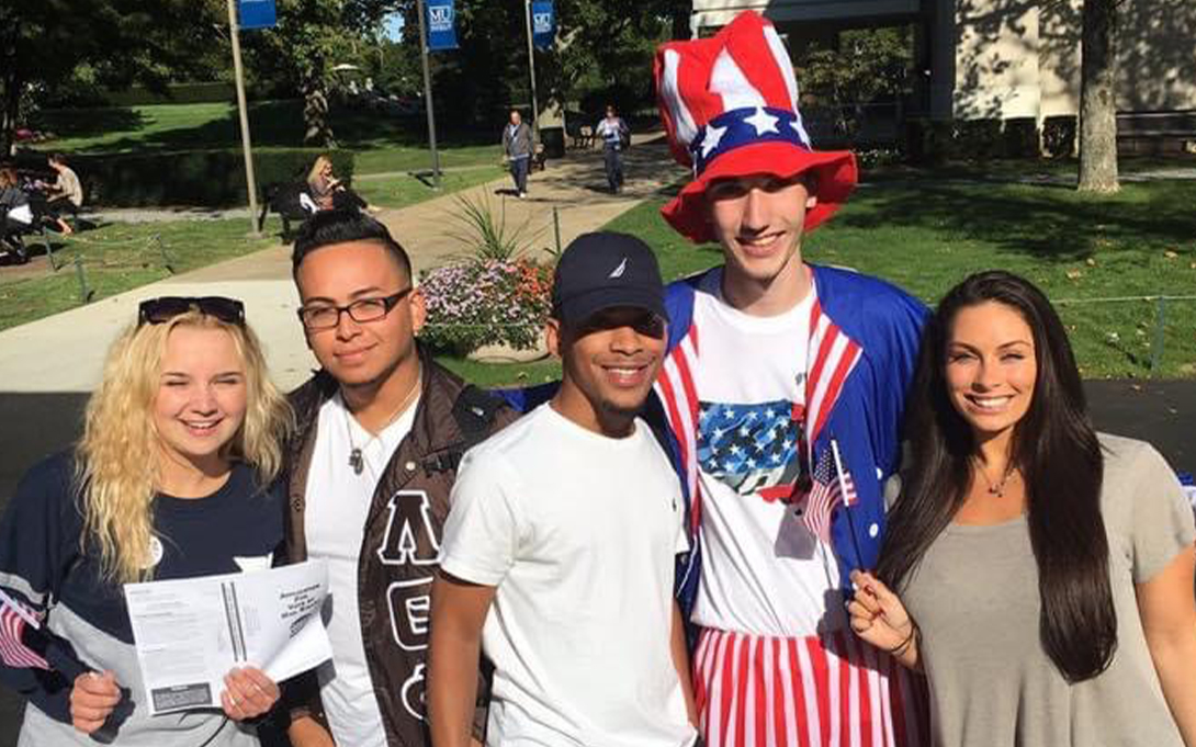 Landon Myers shown with students during a voter registration drive.