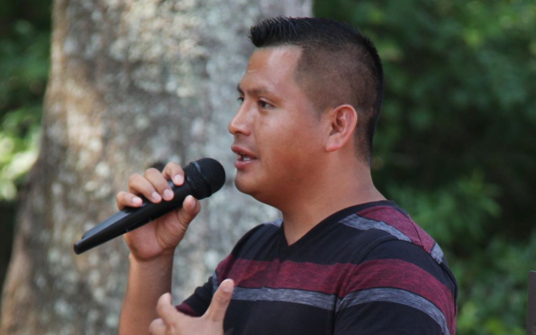 Cruz Salucio speaking into a microphone