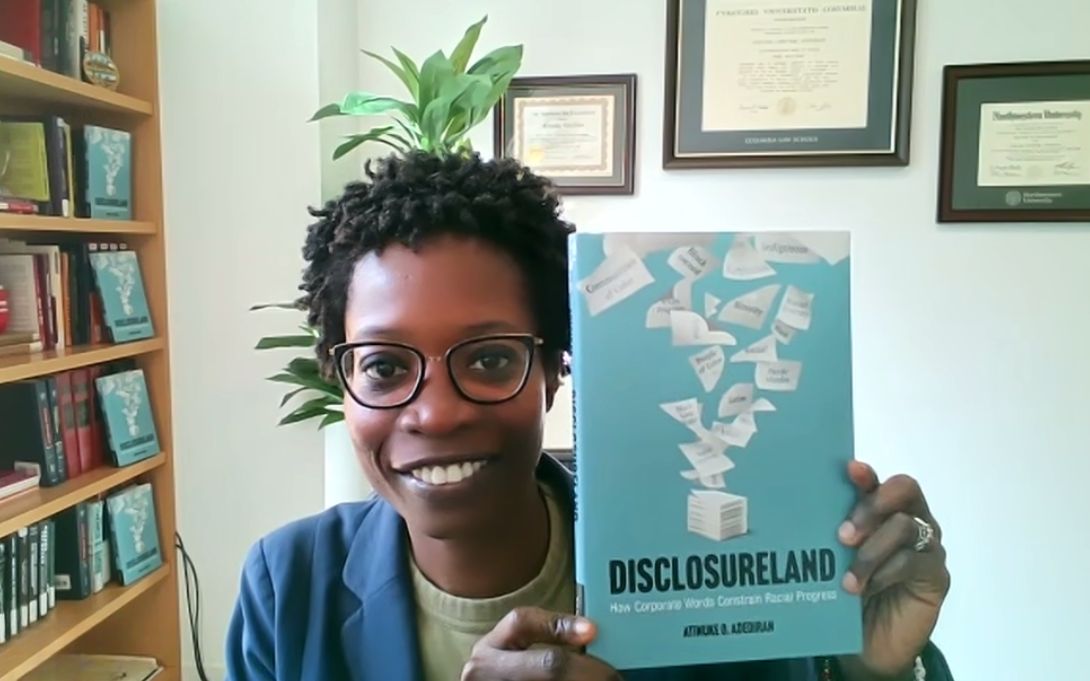 Atinuke Adediran holding a copy of her book Disclosureland 