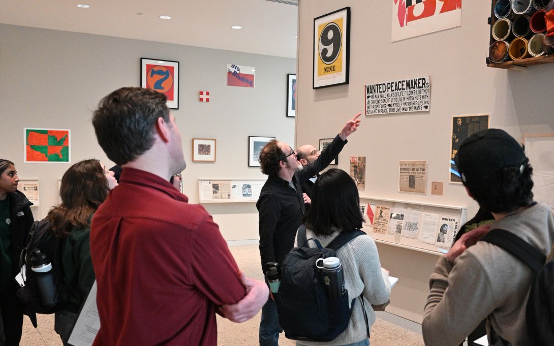 students at the university of michigan museum of art looking at the american sampler exhibit