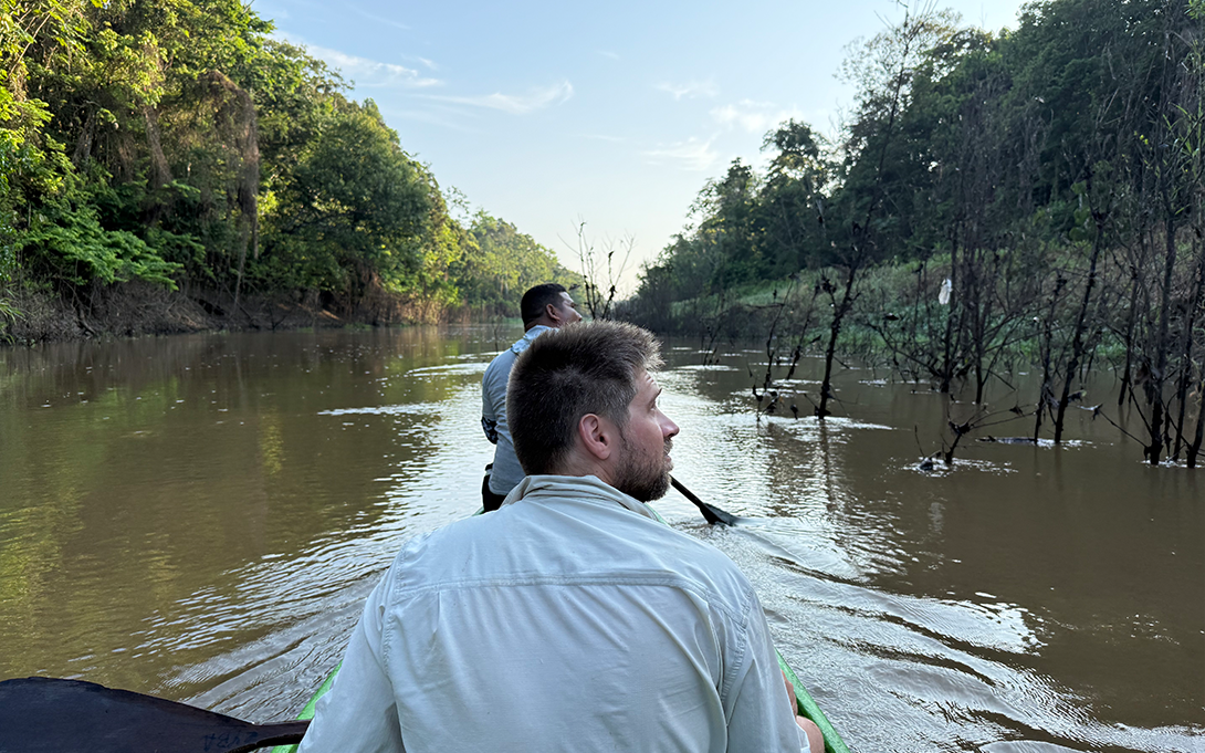 Two men in canoe in body of water