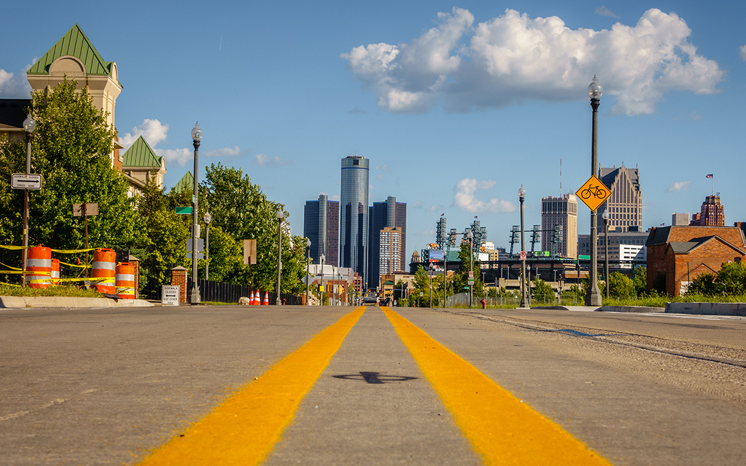 Street with Detroit skyline in the background
