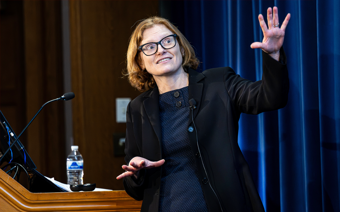Person at a podium giving an animated speech