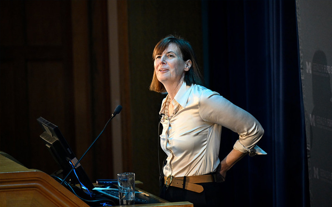 Pamela Herd speaking at the podium  