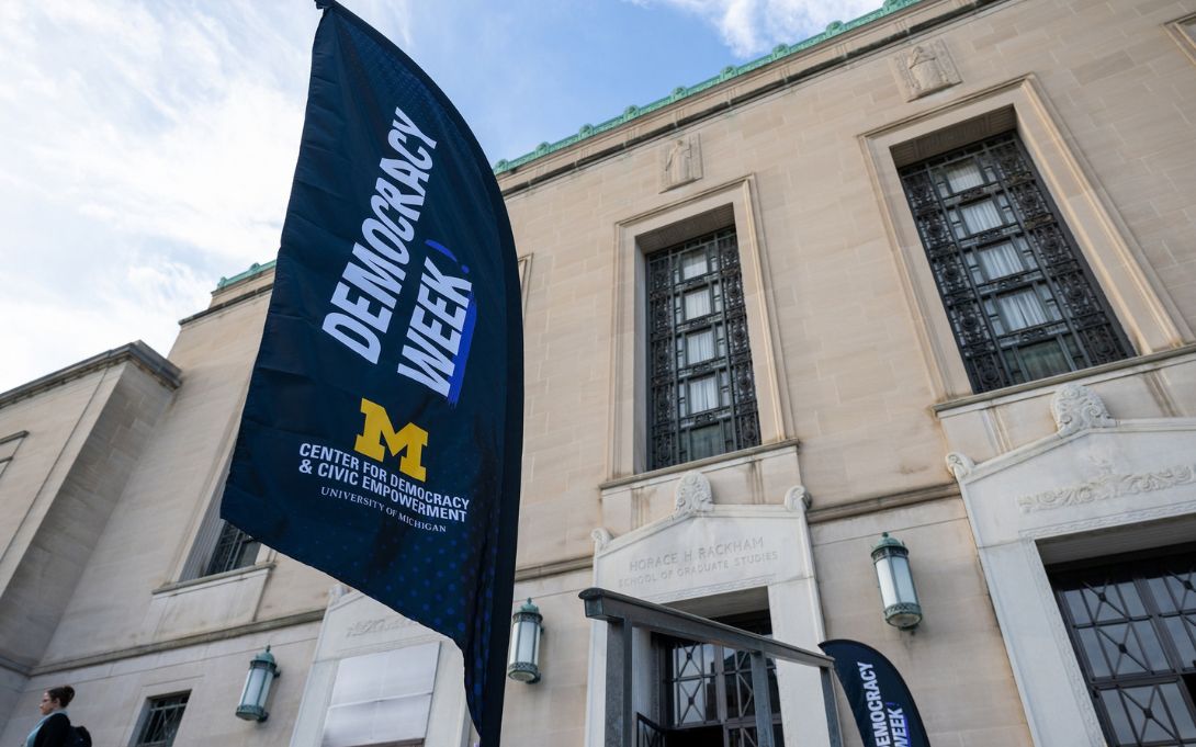 A Democracy Week banner from U-M’s Center for Democracy and Civic Empowerment stands outside the Horace H. Rackham School of Graduate Studies.
