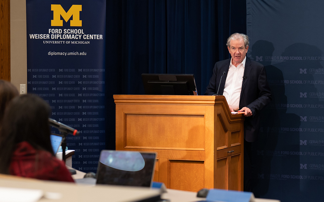 A speaker addresses an audience from a wooden lectern at the University of Michigan’s Weiser Diplomacy Center.