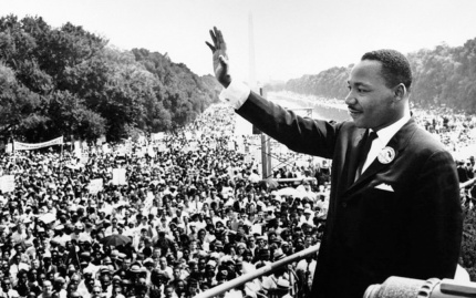 Photo of Rev. Dr. Martin Luther King, Jr. waving to a historic crowed gathered on the Washington Mall