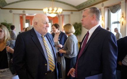Photo of Stephen Biegun (right) speaking with Ambassador Mel Levitsky (left) at a reception in the Rackham Building