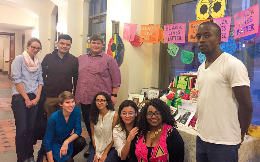 Students gather around an ofrenda for Black lives