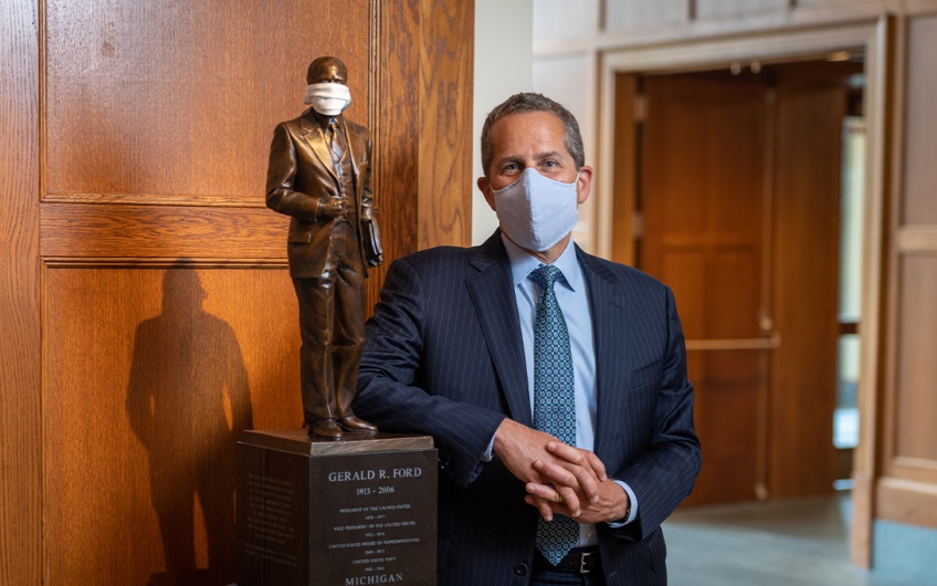 Michael Barr and a scaled replica statue of Gerald R. Ford, both masked amid the COVID-19 pandemic