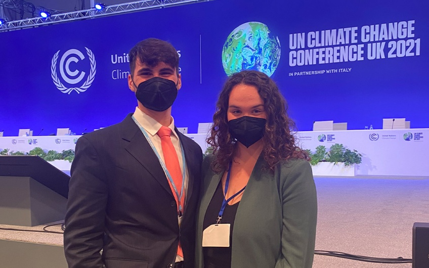 Photo of AJ Convertino and Kristina Curtiss in front of the main stage at COP 21 in Glasgow, UK