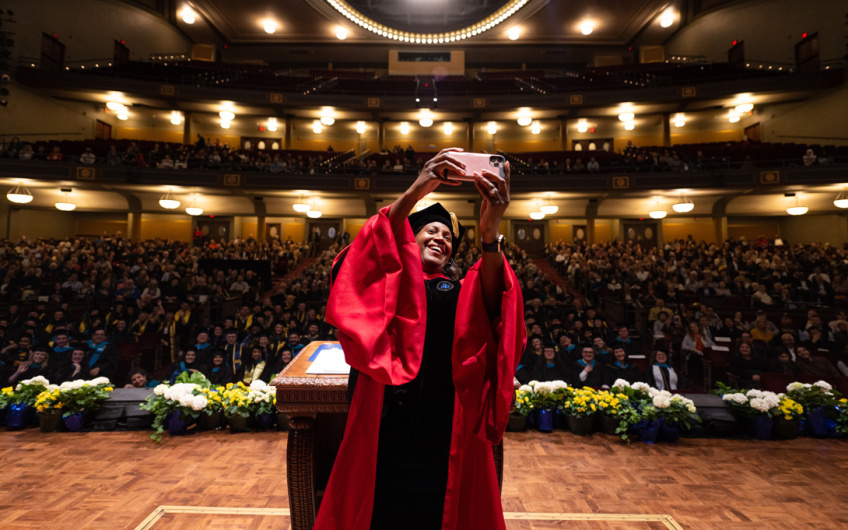 Dean Celeste Wakins-Hayes takes a selfie at Ford School commencement 2023
