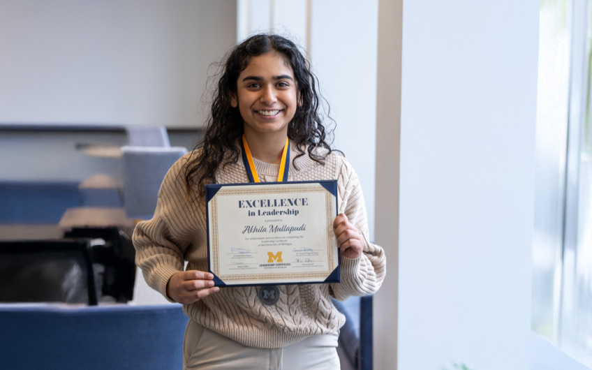 Photo of student displaying their leadership certificate