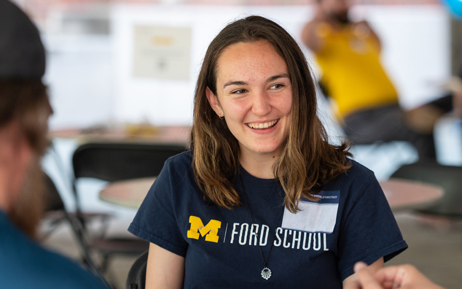 A Ford School student wearing a blue shirt with the Ford School logo