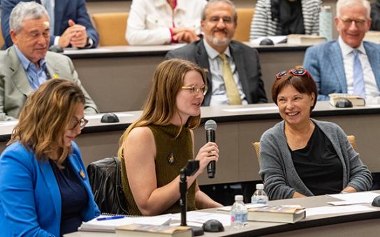 Student asks a question of a visiting speaker
