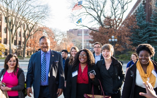 Rev. Jesse Jackson walks with Ford School students on the University of Michigan Diag