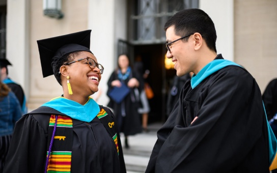 Ford School master's students outside Rackham after graduation