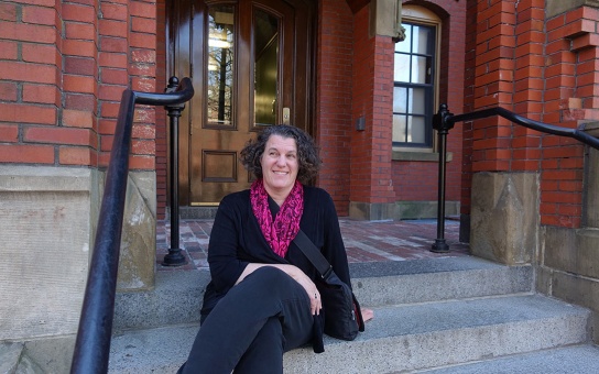 Susan Dynarski sits outside her Harvard freshman dorm