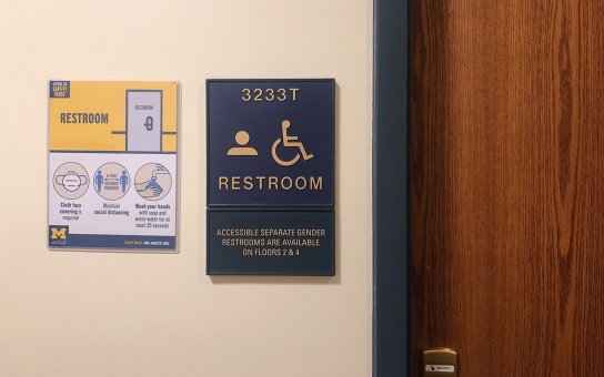 Room placard and door for a gender neutral and accessible restroom in Weill Hall