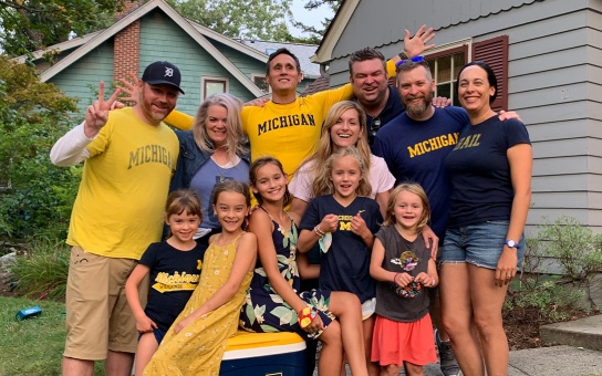 Photo of Ford School alumni and their families at an outdoor football tailgate