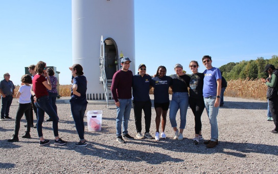 Ford School students standing in front of the base of a wind turbine