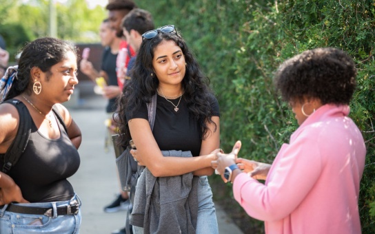 Celeste Watkins-Hayes and two Ford School students in conversation, outdoors in Weill Hall Courtyard, during the Ford School Fall Launch in 2021