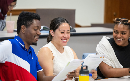 PPIA fellows smiling and studying in lecture hall
