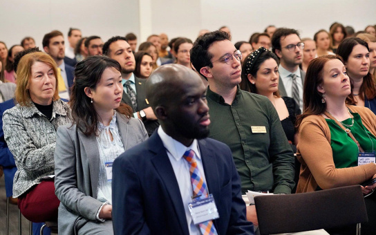 An audience of students, alumni, and friends listen to a discussion between Dean Celeste Watkins-Hayes and Hardy Vieux (MPP/JD ‘97)