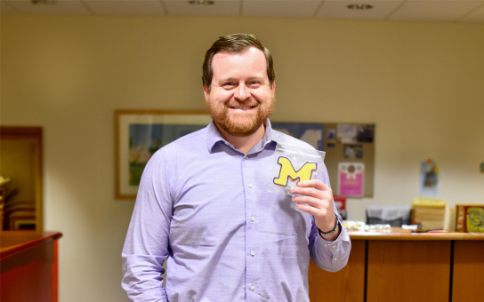 Photo of Eric VanDevender holding block M cookie