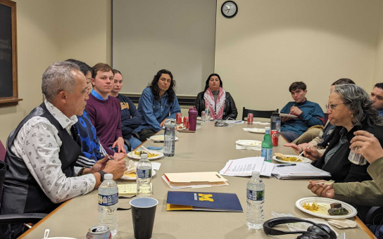 Photo of Yazier Henry and Susan D. Page hosting a dinner conversation with students