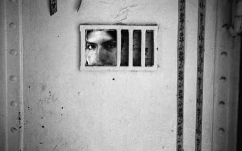 Film still by Francois "Coco" Laso of a man in solitary confinement 