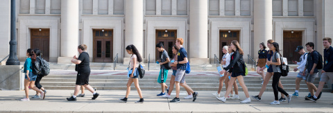 Photo of New Student Orientation participants walking past Hill Auditorium (credit: Michigan Photography)