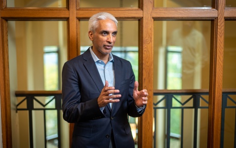 Headshot of Javed Ali at Weill Hall's 4th floor Whitman Lounge, speaking to someone off camera