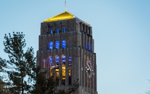 Photo of Burton Tower, with the interior lit in blue and maize lights