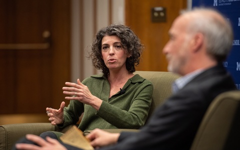 Photo of Molly Ball speaking to an audience at the Ford School, as Craig Gilbert listens.